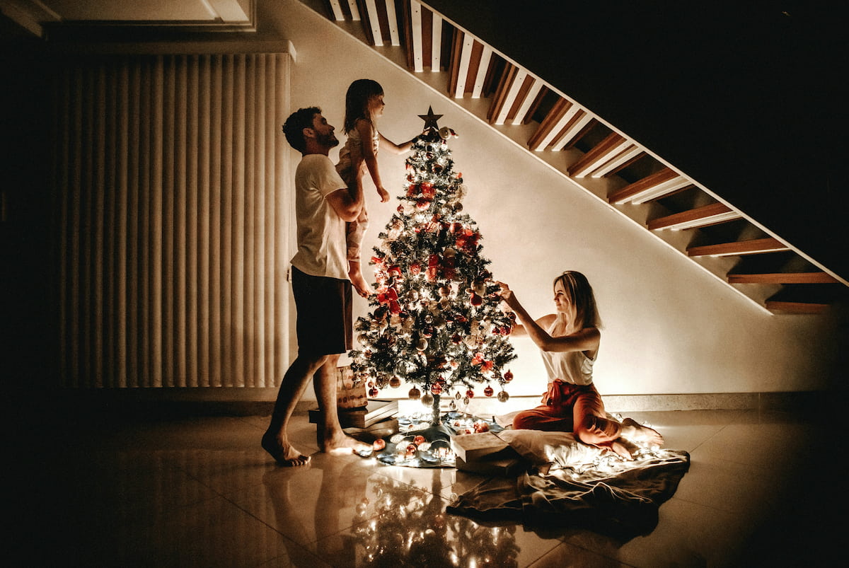 Familia poniendo el árbol de Navidad